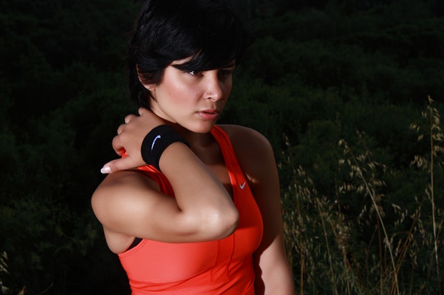 Woman with neck pain outdoors – seeking chiropractic care in Russell Lea